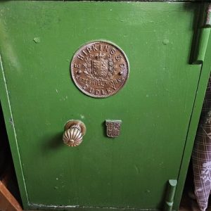 Green Dudley safe with ornate brass plaque, handle and key hole